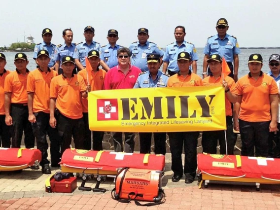 Anthony Mulligan (front row, center) trains members of the Indonesian National Ministry of Search and Rescue to use the EMILY (Emergency Integrated Lifesaving Lanyard) rescue craft in Jakarta.