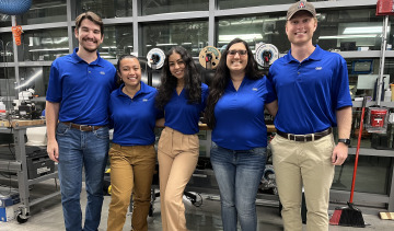 group of people wearing blue t-shirts, smiling