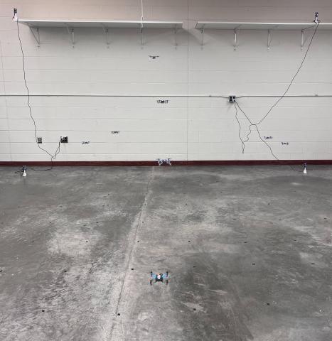 a group of white drones in a cement room.