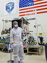 Bradley Williams with the OSIRIS-REx spacecraft in the Lockheed Martin cleanroom. Photo by Symeon Platts/The University of Arizona