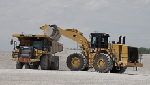 Two large pieces of Caterpillar construction equipment