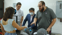 AME associate professor Kavan Hazeli works on a turbine with visually impaired students