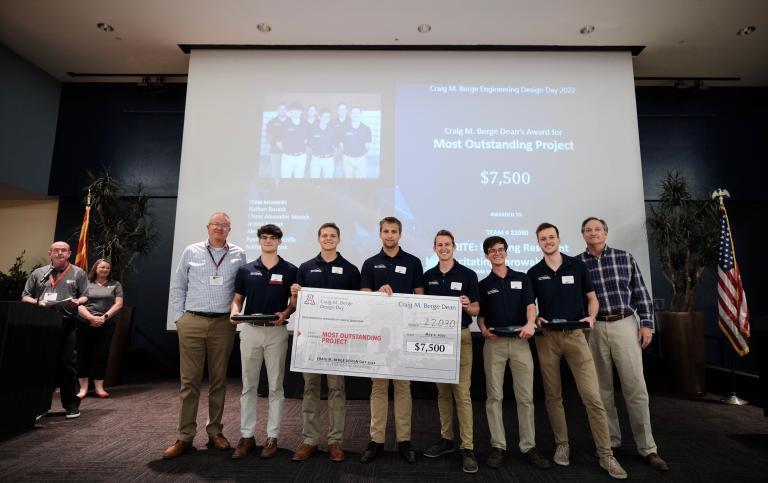 A team of six University of Arizona students hold a large $7,500 check at Design Day 2022.