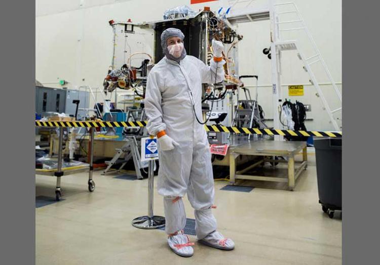 Bradley Williams, a University of Arizona alumnus and employee, and recent recipient of a 2019 Flinn-Brown Fellowship, poses with the OSIRIS-REx spacecraft in the Lockheed Martin cleanroom. 