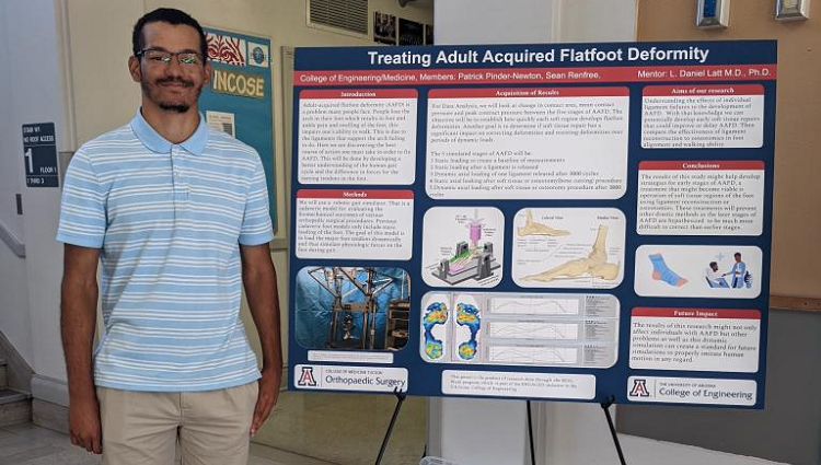 Mechanical engineering major Patrick Pinder-Newton standing with his poster about treating adult acquired flatfoot deformity. 