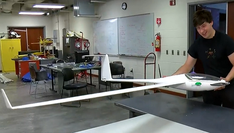 AME student Reed Spurling holding a Mars sailplane in the lab