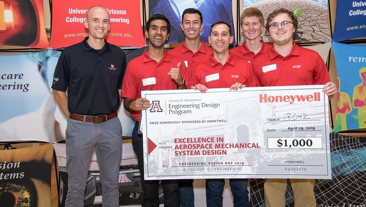 Students holding a large check