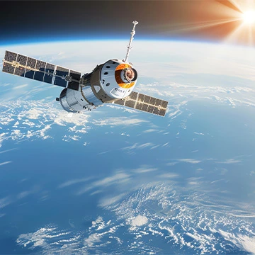 satellite in orbit above earth, sun in background